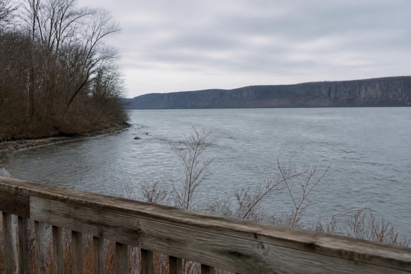 The Hudson River on an overcast afternoon, seen from a riverfront path in the Westchester Rivertowns.