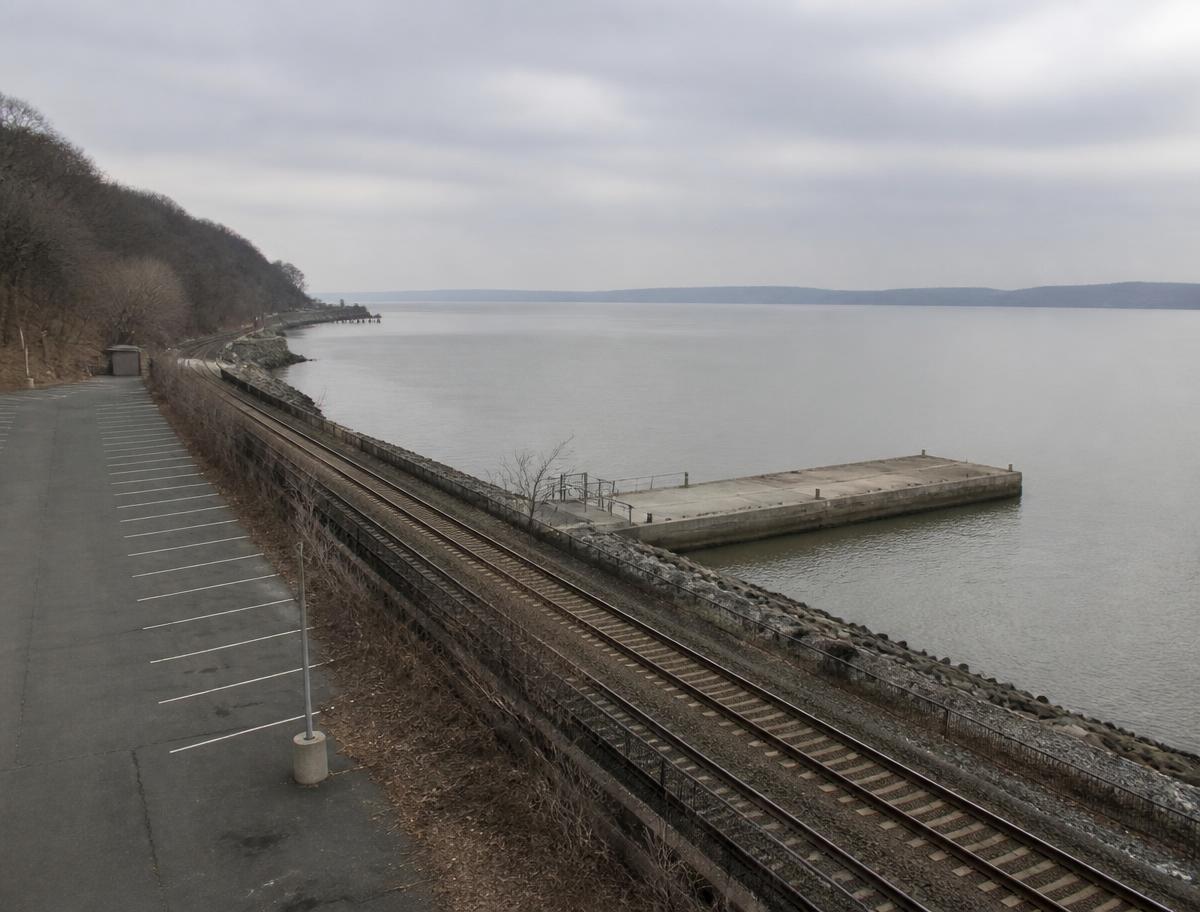 The Ossining waterfront on a grey day, the Hudson Line tracks running south along the river.